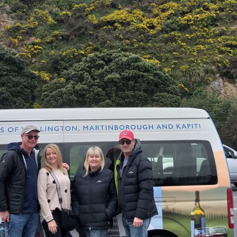 a couple of people that are standing in front of a car
