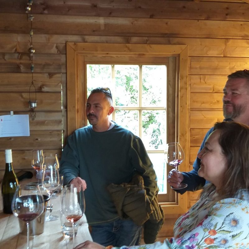 a group of people sitting at a table with wine glasses