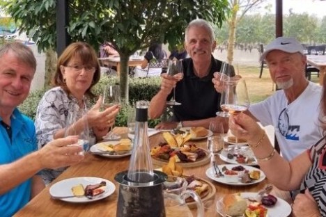 a group of people sitting at a table with wine glasses