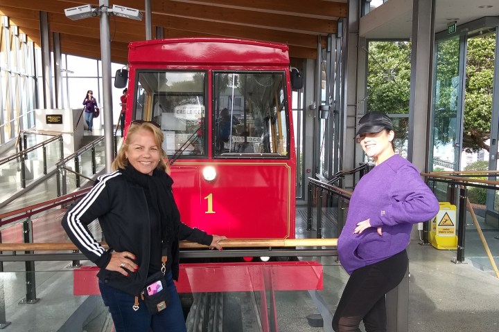 a man and a woman sitting at a bus stop
