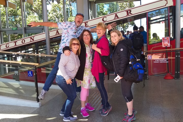 a little girl standing in front of a building