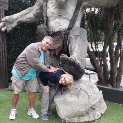 a man and a woman sitting at a zoo