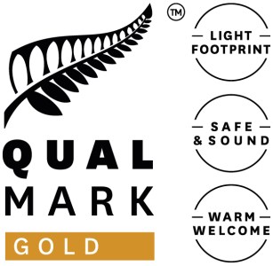 Qualmark Gold Logo with fern leaf and three icons: Light Footprint, Safe & Sound, Warm Welcome.