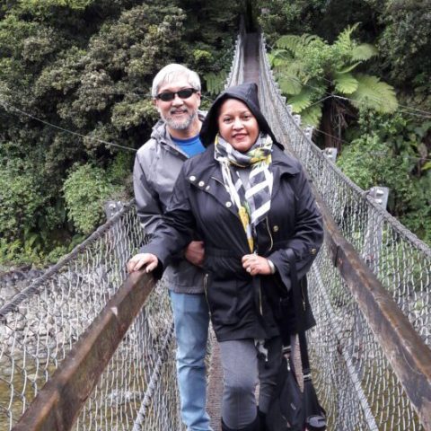 a man standing next to a bridge